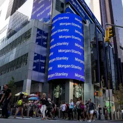 A large blue digital billboard displays "Morgan Stanley" repeatedly, highlighting their significant assets under management in this bustling Times Square scene.