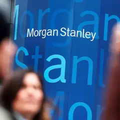 Blurred figures stand before a blue building with the "Morgan Stanley" logo. Investors anticipate the latest Morgan Stanley earnings report.