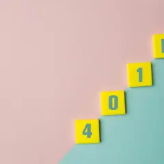 Yellow tiles with numbers 4, 0, 1, and K form a staircase, illustrating the difference between 401a vs 401k retirement plans.