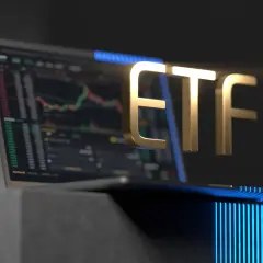 Golden ETF text hovers over a laptop displaying a stock chart, symbolizing investment opportunities.