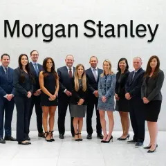 A diverse team of professionals stands in front of the "Morgan Stanley" logo, likely discussing complex financial instruments like Morgan Stanley CDS.