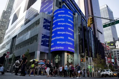 A large blue digital billboard displays "Morgan Stanley" repeatedly, highlighting their significant assets under management in this bustling Times Square scene.