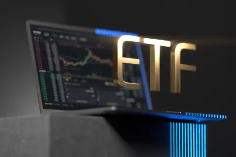 Golden ETF text hovers over a laptop displaying a stock chart, symbolizing investment opportunities.