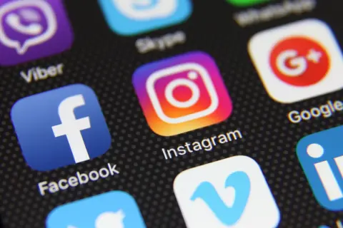 Close-up of a smartphone screen displaying various social media app icons, including Instagram, Facebook, and Viber. This image could represent the diverse digital landscape, much like a "vox etf" offers a diversified investment.