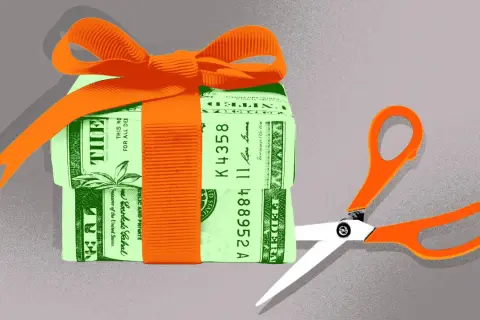 A gift-wrapped stack of money with scissors poised to cut. This symbolizes the potential changes to the gift tax limit in 2026.
