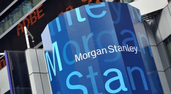 A blue, hexagonal pillar displays the "Morgan Stanley" logo. In the background, an orange digital ticker shows "ADBE" and "91".