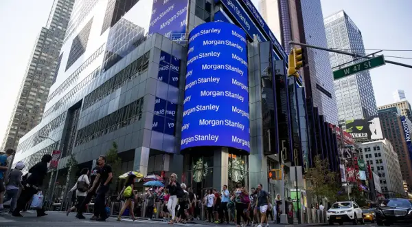 A large blue digital billboard displays "Morgan Stanley" repeatedly, highlighting their significant assets under management in this bustling Times Square scene.