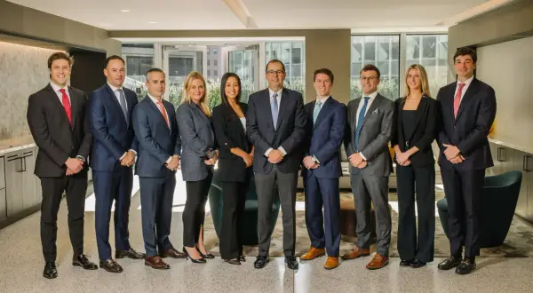 A diverse group of professionals, likely a Morgan Stanley vice president list, pose for a formal photo in a modern office setting.