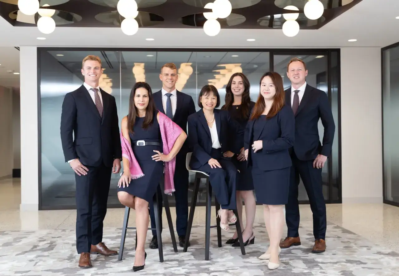 A diverse group of professionals, possibly a Morgan Stanley vice president list, pose for a photo in a modern office setting.