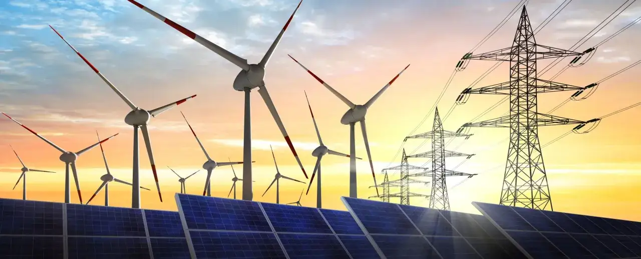 Wind turbines and solar panels at sunset, illustrating how to invest in renewable energy for a sustainable future.