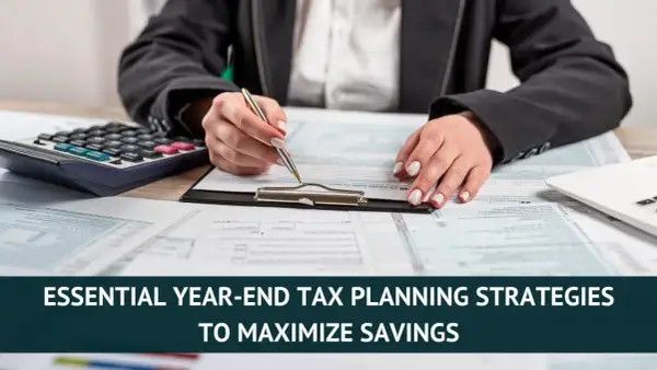 Hands reviewing tax forms with a calculator and laptop, emphasizing year-end tax planning for maximum savings.