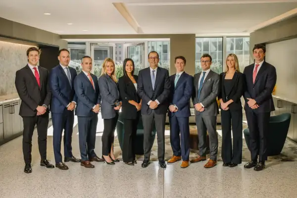 A diverse group of professionals, likely a Morgan Stanley vice president list, pose for a formal photo in a modern office setting.